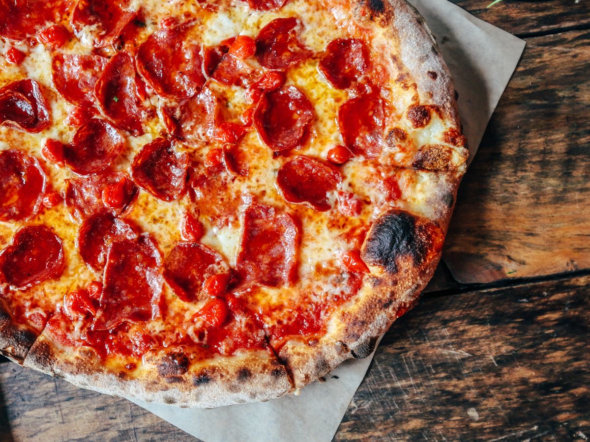 Wood-fired pizza at Renzo's Pizzali kitchen