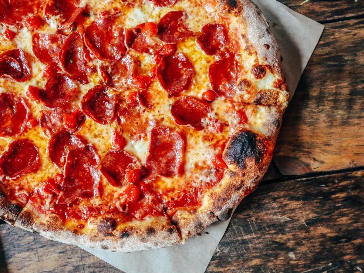 Wood-fired pizza at Renzo's Pizzali kitchen