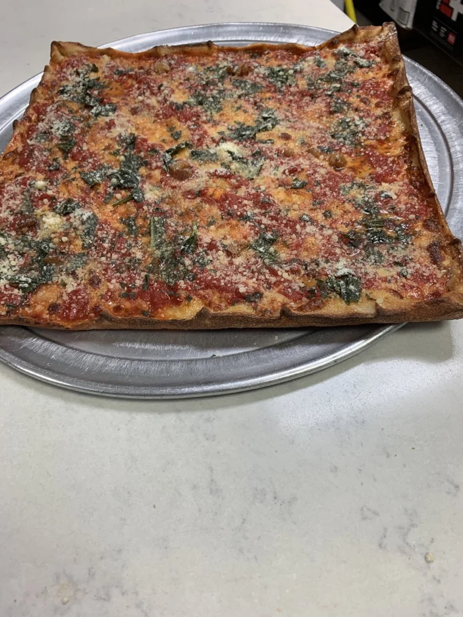 Fresh-made pizza topped with mozzarella